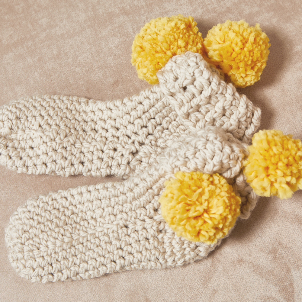  If you’re looking for a cozy little gift for someone small, the Pom Pom Slippers are the cutest gift around. #crochetslippers #crochetpattern #crochetlove #crochetaddict