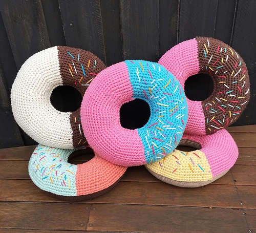 Crochet Donut Cushions - These crochet pillows are fun and an adventure to make. If you’re looking for creative kids pillows, this list will be your go to. #CrochetPillowPatterns #CrochetPatterns #CrochetAddict