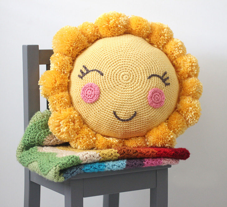 Pom Pom Sunshine Pillow - These crochet pillows are fun and an adventure to make. If you’re looking for creative kids pillows, this list will be your go to. #CrochetPillowPatterns #CrochetPatterns #CrochetAddict