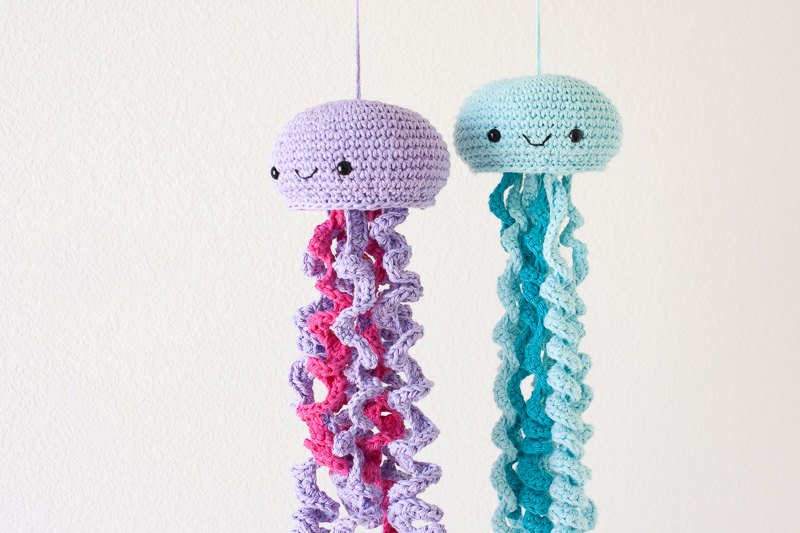 Friendly Jellyfish - Crochet baby mobiles are colorful, fun and creative. Grab your hook and your favorite type of yarn, and get started on a baby mobile for someone you know. #CrochetBabyMobiles #CrochetPatterns #FreeCrochetPatterns