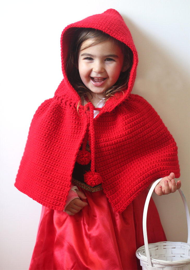 Crochet Little Red Riding Hood Cape - These hooded free crochet scarf patterns are excellent alternatives to full-blown costumes when your kid is not into that kind of thing. #freecrochetscarfpatterns #crochetscarf 