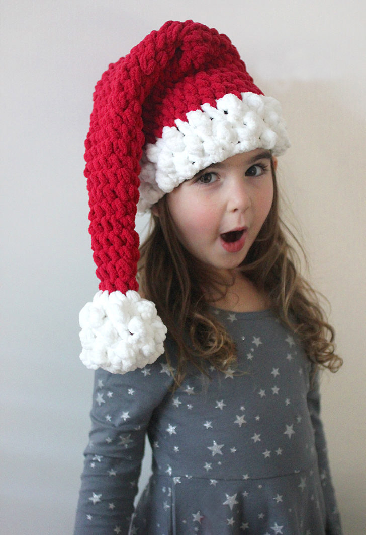 Crochet Santa Hat - This list of Christmas Crochet hat patterns will supply you with anything from the classics (Santa, Rudolph, Snowman) to fun animals and well-loved characters. #ChristmasCrochetHatPatterns #CrochetHatPatterns #CrochetPatterns