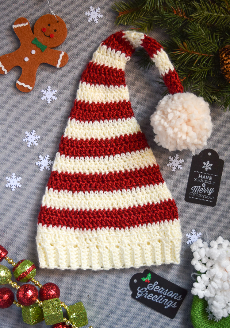 Pixie Elf Striped Newborn Hat - This list of Christmas Crochet hat patterns will supply you with anything from the classics (Santa, Rudolph, Snowman) to fun animals and well-loved characters. #ChristmasCrochetHatPatterns #CrochetHatPatterns #CrochetPatterns