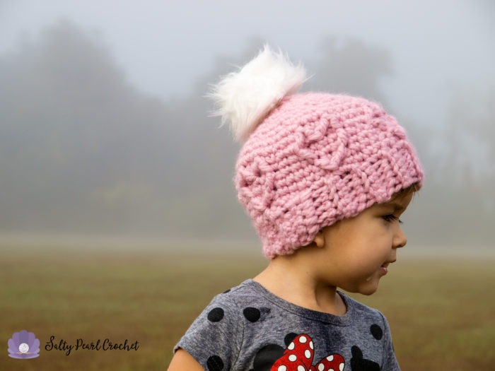 Chunky Cabled Heart Hat - One way you can show your love for kids this Valentine’s is by crocheting these simple crochet patterns. #simplecrochetpatterns #crochetpatterns #kidscrochetpatterns