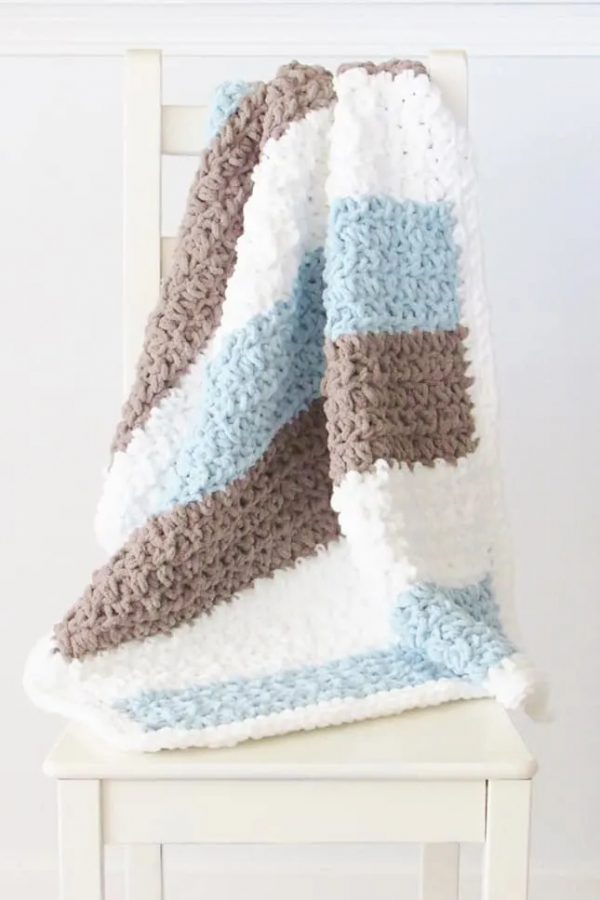 a crochet blanket for little boys on a white chair