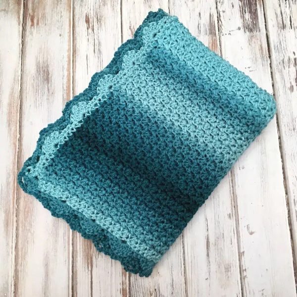 An eegant ombre baby blanket on a wooden surface

