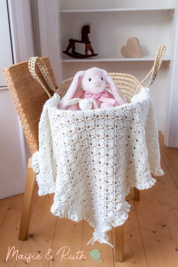 a cute stuffed rabbit on top of the bonnie crochet blanket