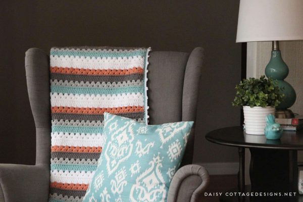 A crochet blanket on a chair