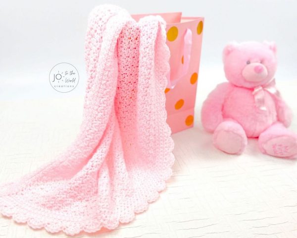 The Simple Crochet Baby Blanket next to a teddy bear
