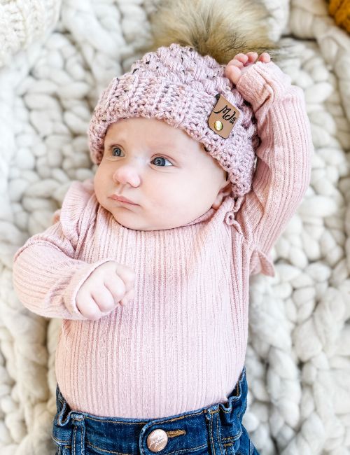 a baby wearing a puff stitch crochet hat