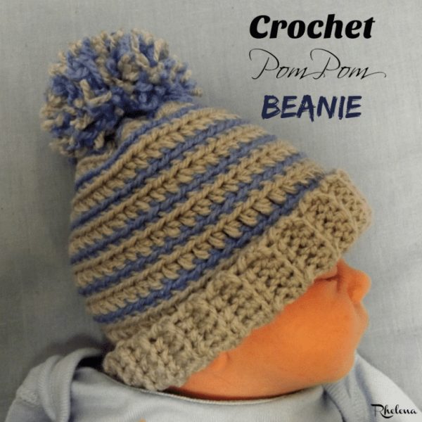 a baby wearing a crochet pom pom beanie