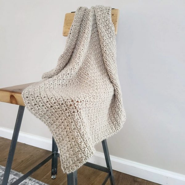 Finley Crochet Baby Blanket on a chair
