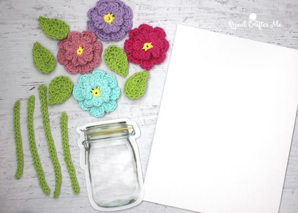 flowers crochet with jar and canvas on the side